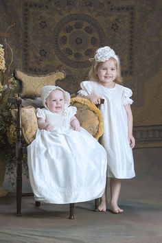 Abigail is a stunning soft white 100% silk dupioni Christening gown that has a smocked bodice with embroidery and seed pearls, crafted by hand. The gown is completely lined with French seams for a soft touch on tender skin. The coordinating bonnet is hand-smocked with ribbon ties, embroidery and pearl accents. Our Christening/Baptism gowns are designed to become a family heirloom that is passed down for generations. Size 3 month generally fits 0-6 months, size 6 month generally fits 6 months to Elegant Fitted Baptism Dress With Smocked Bodice, Cream Dress With Smocked Bodice For Wedding, Cream Wedding Dress With Smocked Bodice, White Wedding Dress With Smocked Back, White Silk Gown For Ceremonies, White Silk Dress With Pearl Embroidery, Smocking Embroidery, Baby Baptism Dress, Heirloom Dresses