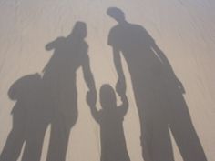 the shadow of two people holding hands and standing next to each other with text that reads natural organized parent