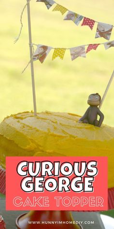 curious george cake topper on a yellow cake with bunting flags in the background