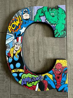 the letter c is decorated with comic characters