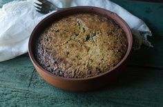 a cake in a bowl with a fork next to it