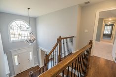 the stairs in this house are made of wood and have wrought iron handrails