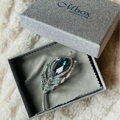 an elegant brooch sits in a box on a blanket