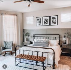 a bed room with a neatly made bed and two pictures on the wall above it