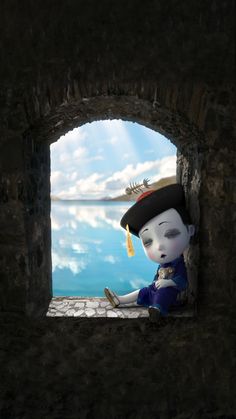 a small doll is sitting on the ledge of a stone wall looking out at water