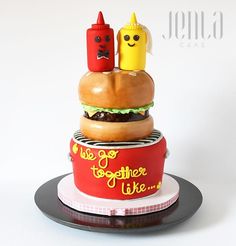 there is a cake made to look like hamburgers and hot dogs on top of each other