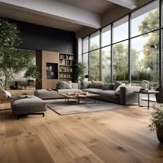 a living room filled with lots of furniture and large glass windows next to a wooden floor