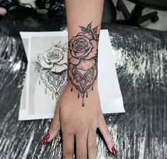 a woman's hand with a rose tattoo on it