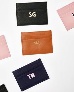 four different colored leather business cards on a white surface with the letters sg, old and new