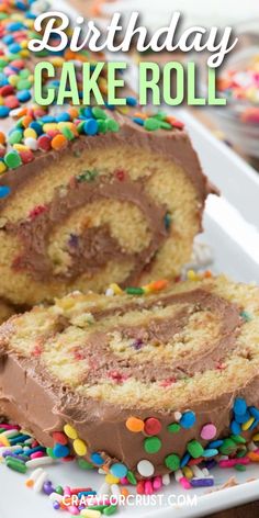 a birthday cake roll with chocolate frosting and sprinkles on a plate