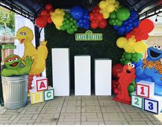 sesame street entrance decorated with balloons and cutouts for children's birthday party decorations