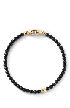 18-karat yellow gold. Black onyx and sapphire. Bracelet, 4mm. Push-clasp closure. Imported. Black Jewelry With Gold Clasp For Formal Occasions, Elegant Black Jewelry With Gold Clasp, Elegant Black Beads Bracelet For Formal Occasions, Elegant Black Beaded Bracelets For Formal Occasions, Luxury Onyx Bracelet With 8mm Beads, Luxury Onyx Jewelry With Black Beads, Luxury Onyx Round Bead Jewelry, Classic Single Strand Onyx Jewelry, Elegant Yellow Gold Bracelets With Black Beads