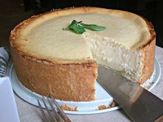 a cheesecake on a plate with a knife and fork