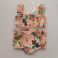 Brand New With Tags In New Condition. Two Piece Floral Swimsuit With Smocking And Ruffle Details. Peach Color With Coral, Purple And Yellow Flowers. Toddler Girl Size 2t. Check Out My Closet For Lots Of Other Kids Listings And 20% Off All Bundles! Pink Ruffled Sets For Vacation, Floral Print Swimwear For Spring Playwear, Pink Ruffled Beach Sets, Pink Floral Print Playwear Sets, Pink Floral Print Sets For Playwear, Fitted Orange Playwear Sets, Purple And Yellow Flowers, Gingham Swimsuit, Toddler Swimsuits