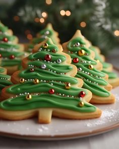 christmas cookies decorated with green icing on a plate