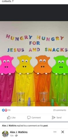 a group of colorful plastic pigs standing in front of a sign that says hungry hungry jesus and snacks