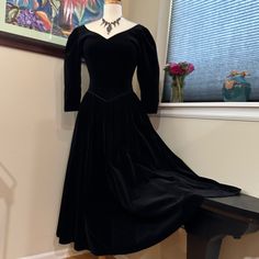 Vintage Velvet 1980's Sexy Elizabethan Gothic Glamour Gown Fit For Royalty! 3/4 Length Sleeves. Deep V-Neckline In Front. Deep U-Neckline In Back. V-Shaped Waistline Echos The V-Shaped Neckline As It Is Shaped To A Deep V In The Center Front Of Waist. Waistline Seam Is Expertly Piped In Heavy Narrow Satin Where Bodice Is Joined To Skirt. The Same Narrow Piping Finishes The Neckline Edges And The Sleeve Cuffs. Dress Is Very Well Made. Bodice Is Princess Seamed Thus Fitted And Sculpted To The Torso. Fastens With Covered Velvet Buttons Up The Back. Sleeves Are Puffed. The Fabric Is A High Quality Weighty Velvet. Made In Great Britain In The Early 1980’s. This Reminds Me Of The Gowns Worn By Black Long Sleeve Vintage Dress For Formal Occasions, Black Vintage Evening Dress For Fall, Fitted Vintage Dress For Formal Winter Event, Fitted Vintage Dress For Winter Formal, Formal Fitted Vintage Dress For Winter, Elegant Vintage Evening Dress For Winter, Retro Long Sleeve Evening Vintage Dress, Retro Long Sleeve Vintage Evening Dress, Retro Full Length Evening Dress