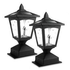 two black outdoor post lights with one light on each side