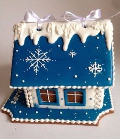 a gingerbread house decorated with icing and snowflakes