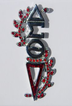 a red and silver brooch with the word love written in it's center