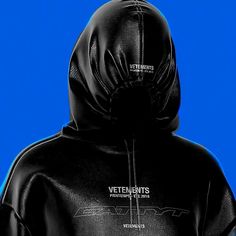 a person wearing a black hoodie with the words vetentents printed on it