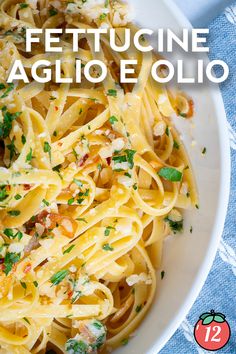 a white bowl filled with pasta and topped with parsley