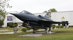 a jet is on display in front of a building