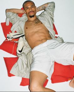 a man laying on top of a red and white blanket