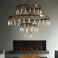 a chandelier hanging over a fireplace in a living room