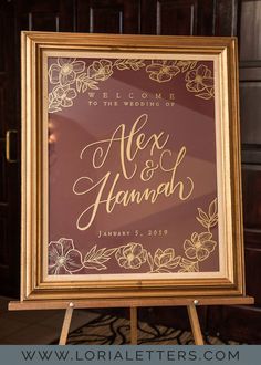 a sign that says alex and hannah is on display in front of a wooden door