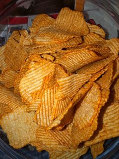 a bowl filled with potato chips on top of a table