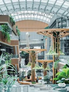 the inside of a building with lots of plants and trees in it's atrium