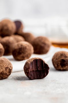 chocolate truffles on a white plate next to some other food items and spoons