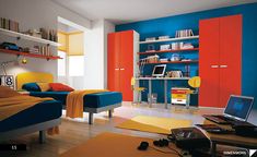 a bedroom with orange, blue and yellow decor on the walls is pictured in this image