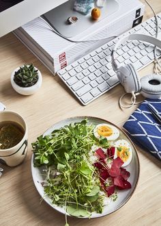 a white plate topped with lots of veggies next to a keyboard