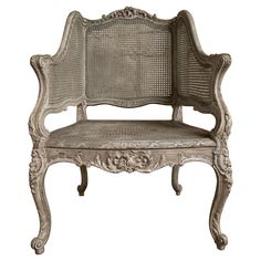 an old chair with wicker seat and backrests on white background, side view