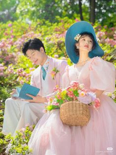 a man and woman sitting on the ground with flowers in their hair, reading books