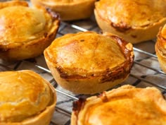 several baked pastries sitting on top of a cooling rack