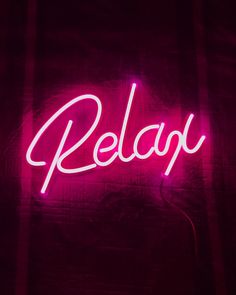 a neon sign that says relax on it