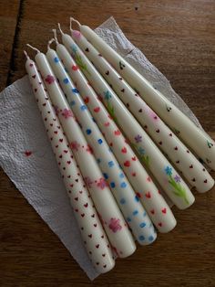 six candles are lined up on a napkin