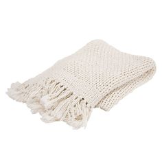 a white knitted blanket with fringes on the bottom and one end folded up