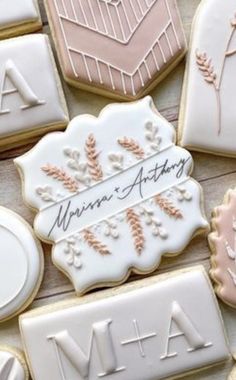 decorated cookies with the names of two couples and their initials are arranged on a table