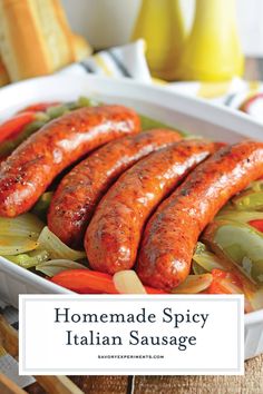 homemade spicy italian sausage with peppers and onions in a white dish on a wooden table