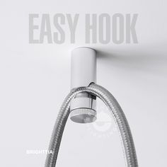 an easy hook is attached to the side of a wall with a hose running through it