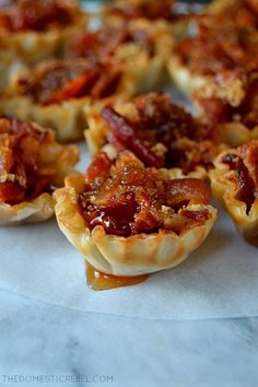 mini bacon pies are lined up on a plate