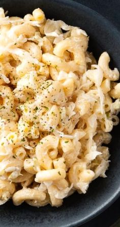 a bowl filled with macaroni and cheese on top of a table