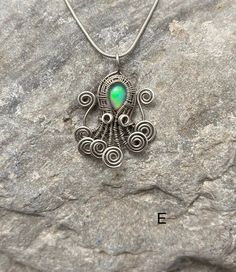 "Octopus themed pendant with natural labradorite or Ethiopian opal stones.  These octopus friends are for the exact item in the photographs with one exception:  Option F - mini blue faceted will be one of the same size and design but will vary since they are all handmade. To keep the price down on that little guy I will not take new photos of any that I made. It will be the same size with a little blue faceted labradorite in it similar to the photo.  A - copper wire with a little opal  B - sterling silver wire with a blue opal C - sterling silver wire with a little opal  D - antique sterling silver wire with little faceted moonstone F - antique sterling silver wire with little opal G - antique sterling silver wire with little opal  Silver octopus friends ship with 18\" silver clad chain in Silver Ocean-inspired Wire Wrapped Jewelry, Wire Wrapped Octopus, Ocean-inspired Wire Wrapped Jewelry For Gifts, Silver Opal Wire Wrapped Necklace, Wire Wrap Seahorse, Octopus Wire Wrap, Aluminum Wire Jewelry, Mini Blue, Bijoux Fil Aluminium