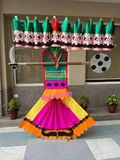 a colorful display in front of a building with lots of decorations on top of it