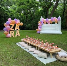 an outdoor party setup with balloons and decorations