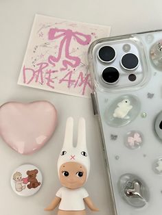 there is a phone case with an image of a bunny on it and some buttons